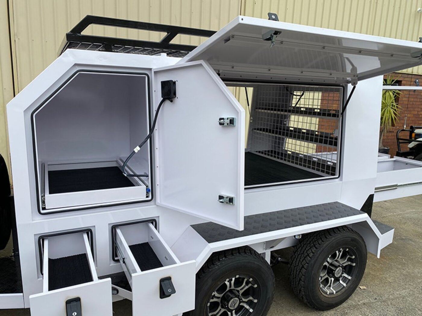 Gen 3 tradie trailer with the side hatch open showing racked storage