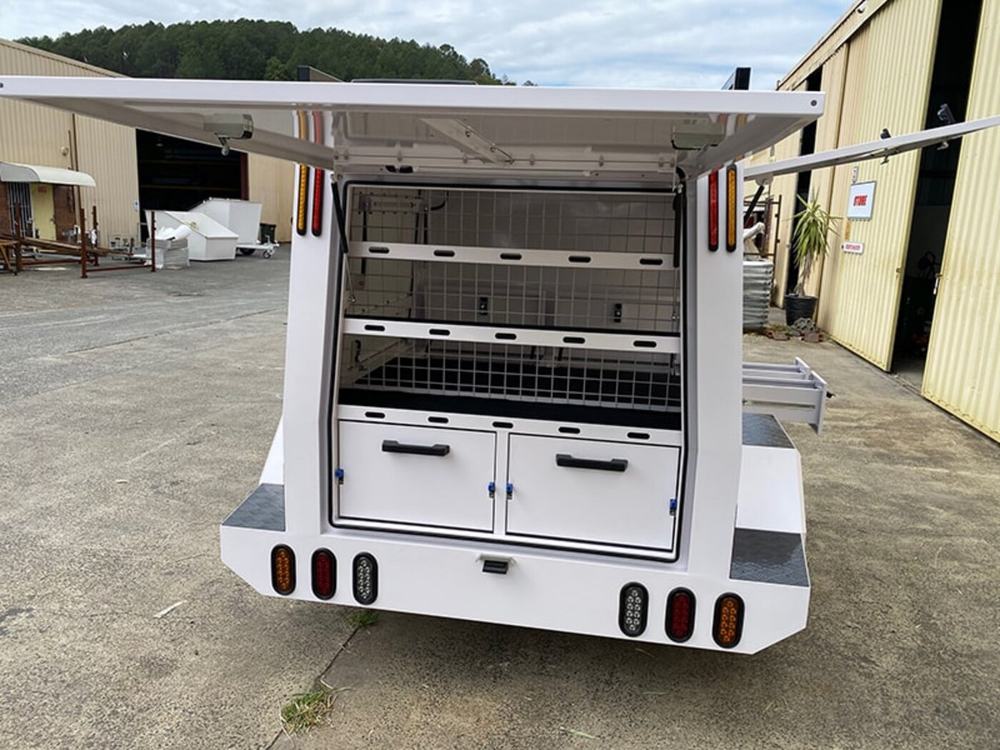 Rear of a tradie trailer with mesh shelving and twin doors